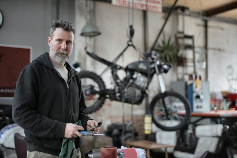 Man in Black Jacket Holding Screwdriver