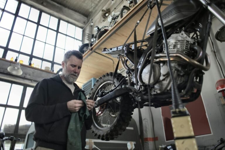 Man in Black Jacket Standing Beside Black Motorcycle